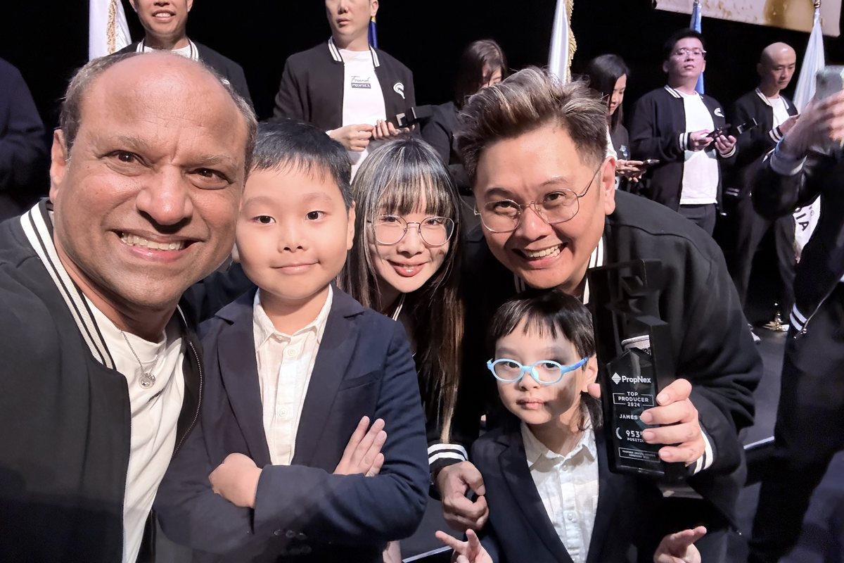 James Lim celebrating an award win with mentors and family.